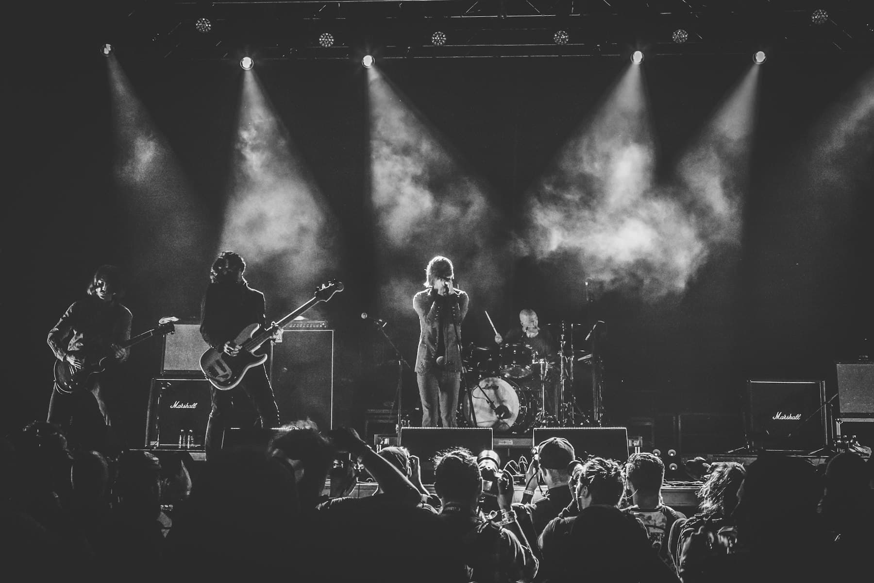 Black and white photograph of a band performing on stage
