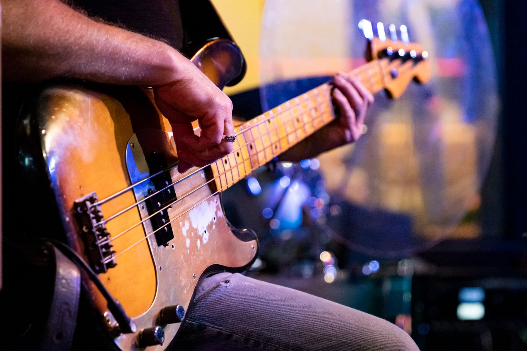 Close up of a musician playing a bass guitar