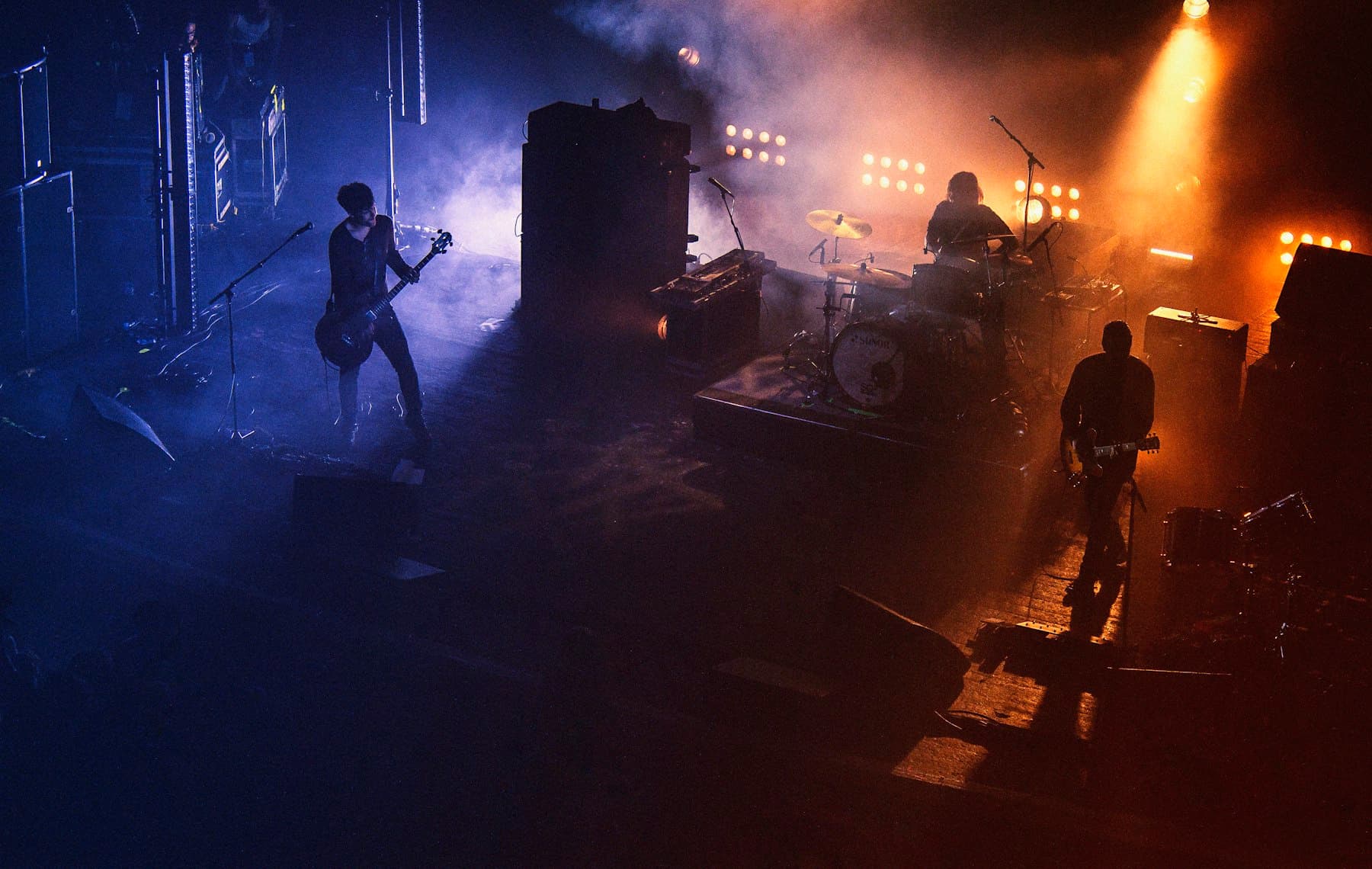 Three musicians performing together on stage